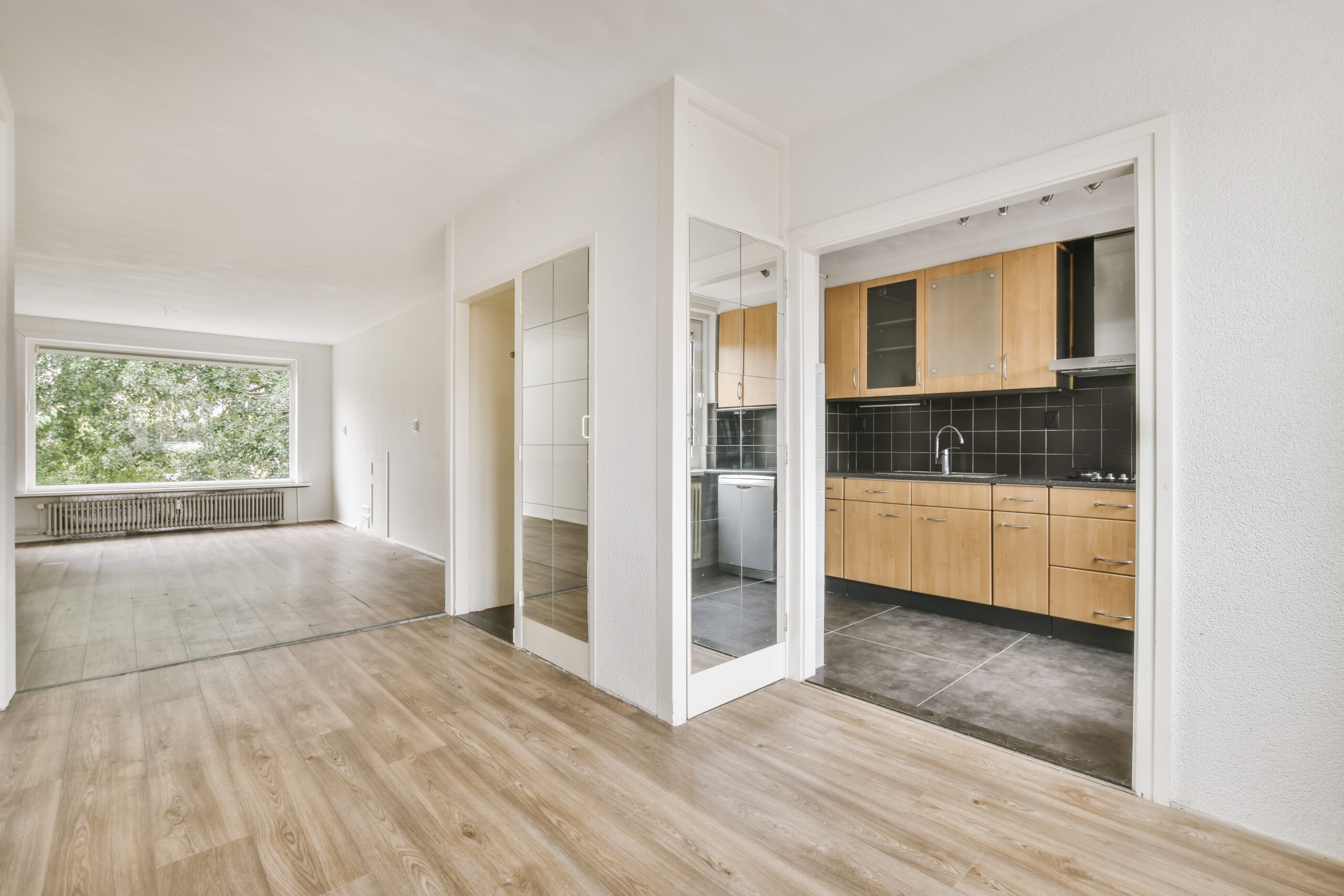 A breathtaking daylight room with an archway leading to the kitchen